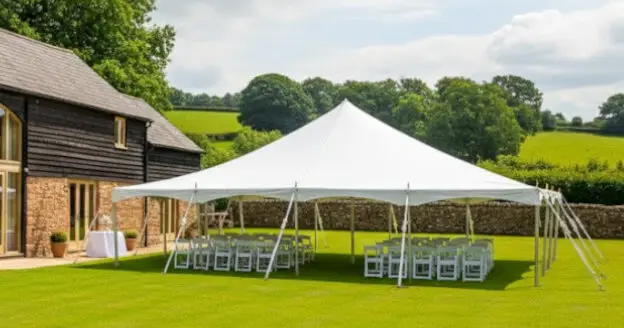 9m x 12m white PVC traditional marquee being used for a wedding at a barn wedding venue